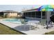 Backyard inground pool with umbrella and chairs, perfect for relaxing at 474 Elm Nw Ave, Port Charlotte, FL 33952