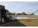 Cozy backyard featuring a fenced in pool, chairs, and umbrella at 474 Elm Nw Ave, Port Charlotte, FL 33952