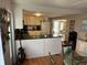 Bright and airy kitchen with black countertops and a view into the dining area at 5025 Palena Blvd., North Port, FL 34287