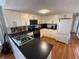 Well-equipped kitchen featuring modern appliances, ample cabinet space and black countertops at 5025 Palena Blvd., North Port, FL 34287