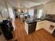 Open-concept kitchen with black countertops, modern appliances, and dining area at 5025 Palena Blvd., North Port, FL 34287