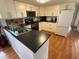 Well-equipped kitchen featuring modern appliances, ample cabinet space and black countertops at 5025 Palena Blvd., North Port, FL 34287