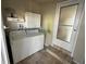 Neat laundry area includes appliances, overhead storage, decor, and convenient outdoor access at 5025 Palena Blvd., North Port, FL 34287
