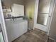 Functional laundry room with washer, dryer, storage cabinets, and exterior access at 5025 Palena Blvd., North Port, FL 34287