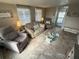 Comfortable living room with tile floors, natural light, and cozy furnishings at 5025 Palena Blvd., North Port, FL 34287