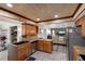 Well-lit kitchen with wood-look ceiling, cabinets, granite countertops, and stainless steel appliances at 599 Encarnacion St, Punta Gorda, FL 33983