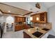 Well-lit kitchen with wood-look ceiling, cabinets, granite countertops, and view to dining room at 599 Encarnacion St, Punta Gorda, FL 33983