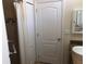 Bright bathroom showcases shower with mosaic tile accents and white doors at 6379 Grand Cypress Blvd, North Port, FL 34287