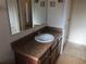 Well-lit bathroom features a vanity with a sink and a large mirror at 6379 Grand Cypress Blvd, North Port, FL 34287