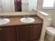 Bathroom vanity features a single sink, wooden cabinetry, and a neutral color scheme at 6379 Grand Cypress Blvd, North Port, FL 34287