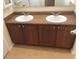 Bathroom with double vanity, granite counter tops and cherry wood cabinets at 6379 Grand Cypress Blvd, North Port, FL 34287