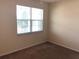 Bright bedroom with a large window providing natural light at 6379 Grand Cypress Blvd, North Port, FL 34287