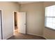 Bedroom featuring a window, closet, and doorway to an adjoining bathroom at 6379 Grand Cypress Blvd, North Port, FL 34287
