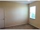 Spacious bedroom features neutral paint, a window, and carpeting at 6379 Grand Cypress Blvd, North Port, FL 34287