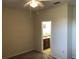 Bedroom with ceiling fan, neutral color paint, carpet, and a view of the bathroom at 6379 Grand Cypress Blvd, North Port, FL 34287