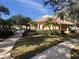 Community clubhouse with lush tropical landscaping and mature trees at 6379 Grand Cypress Blvd, North Port, FL 34287