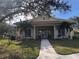 Clubhouse with inviting entrance, lush landscaping, and well-maintained lawn at 6379 Grand Cypress Blvd, North Port, FL 34287