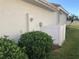 Exterior shot of a home's side, showcasing landscaping and architectural details at 6379 Grand Cypress Blvd, North Port, FL 34287