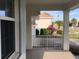 Home's covered entrance porch with brick pavers, white railing, view to driveway and surrounding homes at 6379 Grand Cypress Blvd, North Port, FL 34287