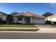 Charming single-story home with a well-manicured lawn, lush landscaping, and a two-car garage at 6379 Grand Cypress Blvd, North Port, FL 34287
