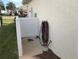 Home exterior with a small, enclosed patio area and lush landscaping at 6379 Grand Cypress Blvd, North Port, FL 34287