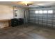 Spacious garage with overhead lighting and ample room for storage, featuring convenient garage door access at 6379 Grand Cypress Blvd, North Port, FL 34287