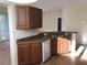 Kitchen with wooden cabinets, stainless steel sink, and modern white appliances including an oven at 6379 Grand Cypress Blvd, North Port, FL 34287