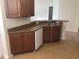 Kitchen featuring stainless steel sink, white dishwasher, and wood cabinets at 6379 Grand Cypress Blvd, North Port, FL 34287