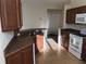 Well-lit kitchen with stainless steel sink, wood cabinets, and tile flooring at 6379 Grand Cypress Blvd, North Port, FL 34287