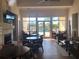 Bright community lounge area featuring tables, chairs, a fireplace, and access to the pool at 6379 Grand Cypress Blvd, North Port, FL 34287