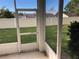 View from screened patio of manicured lawn and community landscape at 6379 Grand Cypress Blvd, North Port, FL 34287