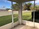 View from screened patio of manicured lawn and community landscape at 6379 Grand Cypress Blvd, North Port, FL 34287