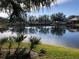 Picturesque pond view with lush greenery and reflections of trees at 6379 Grand Cypress Blvd, North Port, FL 34287