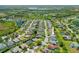 Wide aerial shot showcases the property's location in a tranquil neighborhood with ponds and mature trees at 7344 Arrowhead Run, Lakewood Ranch, FL 34202