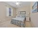 Cozy bedroom with a comfortable queen-sized bed, stylish linens, and ample natural light at 7344 Arrowhead Run, Lakewood Ranch, FL 34202