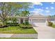 Charming single-story home with well-manicured lawn, lush landscaping, and a spacious driveway leading to a two-car garage at 7344 Arrowhead Run, Lakewood Ranch, FL 34202