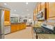 Open-concept kitchen with stainless steel appliances, granite counters, and a seamless flow to the living area at 7344 Arrowhead Run, Lakewood Ranch, FL 34202