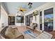 Covered patio with comfortable seating, a ceiling fan, TV, and views of the pool area at 7344 Arrowhead Run, Lakewood Ranch, FL 34202