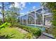 A serene pool surrounded by lush foliage, offering a private and peaceful escape in the screened in backyard at 7344 Arrowhead Run, Lakewood Ranch, FL 34202