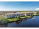 Aerial view of condo complex by the bay with a long dock at 95 N Marion Ct # 226, Punta Gorda, FL 33950
