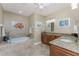 Spacious bathroom featuring a tub, granite counters, and double sinks at 95 N Marion Ct # 226, Punta Gorda, FL 33950