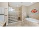 Beautiful bathroom featuring a glass block shower, soaking tub, and elegant tilework for a spa-like experience at 95 N Marion Ct # 226, Punta Gorda, FL 33950