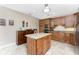 Kitchen with a center island, custom wood cabinetry, stainless steel appliances, and granite countertops at 95 N Marion Ct # 226, Punta Gorda, FL 33950