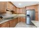 Cozy kitchen featuring stainless steel appliances, granite countertops, and ample wood cabinets at 95 N Marion Ct # 226, Punta Gorda, FL 33950