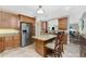 Spacious kitchen with stainless steel appliances, granite countertops, a central island, and hardwood floors at 95 N Marion Ct # 226, Punta Gorda, FL 33950