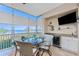 Outdoor bar setup with mini-fridge in enclosed lanai with water views at 95 N Marion Ct # 226, Punta Gorda, FL 33950