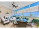 Enclosed lanai with seating, ceiling fan, water views, and tile flooring at 95 N Marion Ct # 226, Punta Gorda, FL 33950