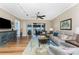 Living room with hardwood floors, area rug, comfortable seating, and sliding doors to a balcony overlooking the water at 95 N Marion Ct # 226, Punta Gorda, FL 33950