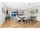 Open-concept floor plan with hardwood floors, a dining table, a view of the water, and an adjacent living area at 95 N Marion Ct # 226, Punta Gorda, FL 33950