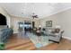 Bright living room featuring modern furnishings, wood flooring, and sliding doors to the outdoor patio at 95 N Marion Ct # 226, Punta Gorda, FL 33950